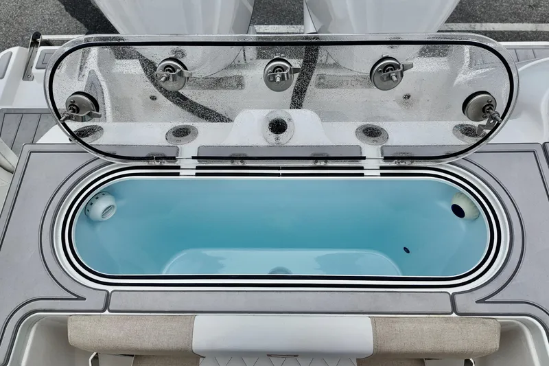Slide: The Image of Livewell on 2026 Sea Fox 288 Commander boat, open lid, blue interior. - 10
