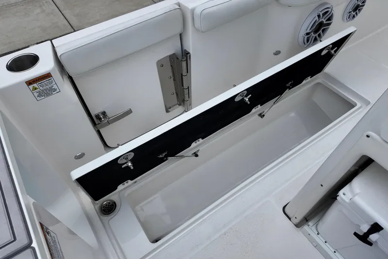 Slide: The Image of 2026 Sea Fox 288 Commander boat storage compartment with open hatch and speakers. - 14