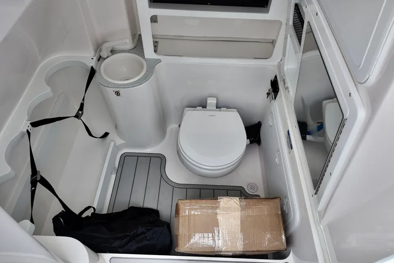 Slide: The Image of 2026 Sea Fox 288 Commander boat interior with toilet, storage, and mirror. - 18