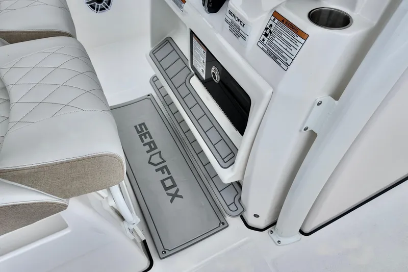 Slide: The Image of 2026 Sea Fox 288 Commander interior, featuring cushioned seating and branded floor mat. - 21