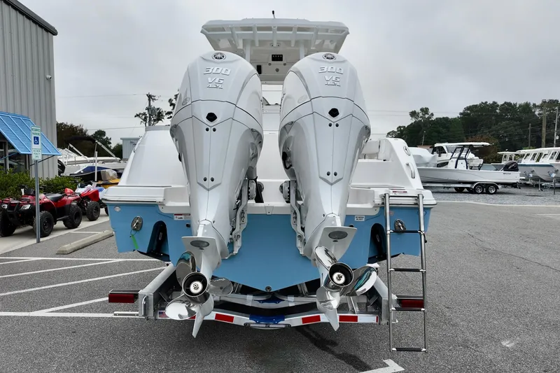 Slide: The Image of 2026 Sea Fox 288 Commander with dual outboard engines, parked in a marina. - 5