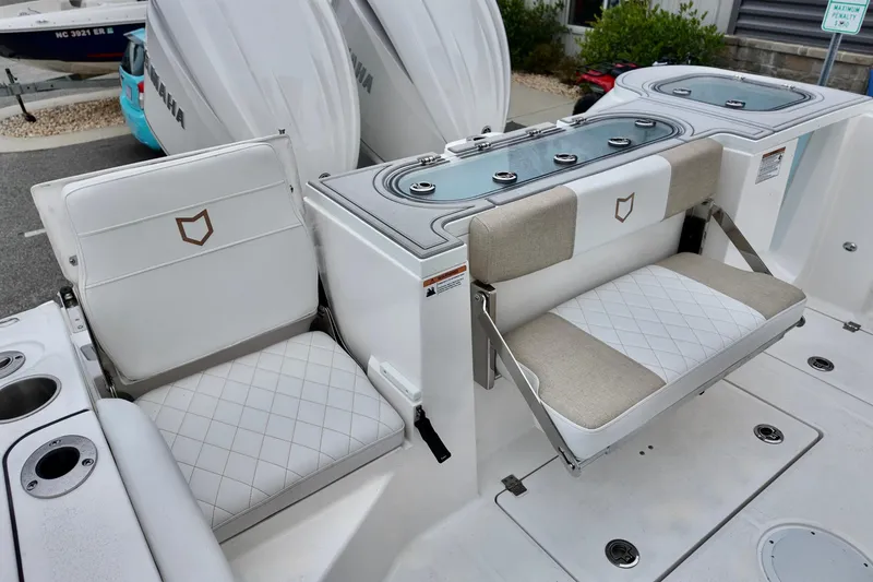 Slide: The Image of 2026 Sea Fox 288 Commander boat seating and storage area with Yamaha engines. - 9