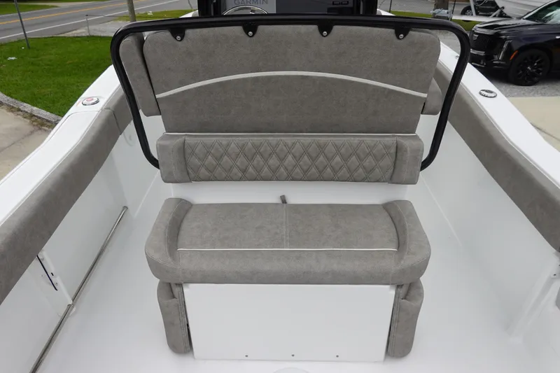 Slide: The Image of 2026 Sea Hunt Ultra 245 SE boat seating with gray cushioned upholstery and diamond stitching. - 10