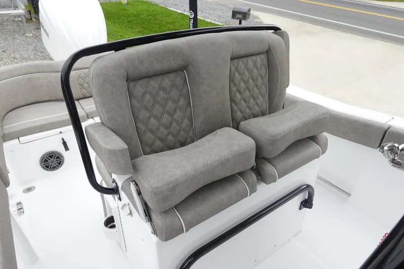 Slide: The Image of 2026 Sea Hunt Ultra 245 SE boat with plush, diamond-stitched seating and armrests. - 13