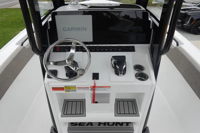 Slide: The Image of 2026 Sea Hunt Ultra 245 SE boat console with Garmin display and steering wheel. - 15