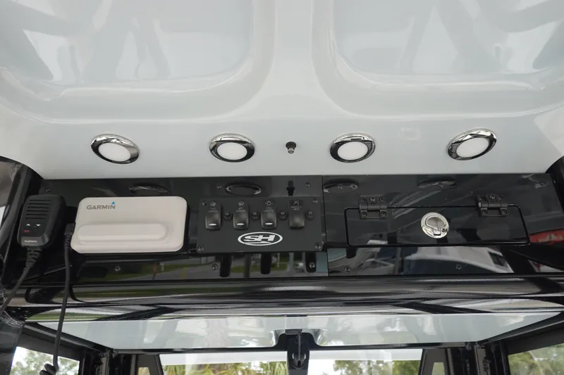 Slide: The Image of 2026 Sea Hunt Ultra 245 SE dashboard with Garmin device and control panel. - 18