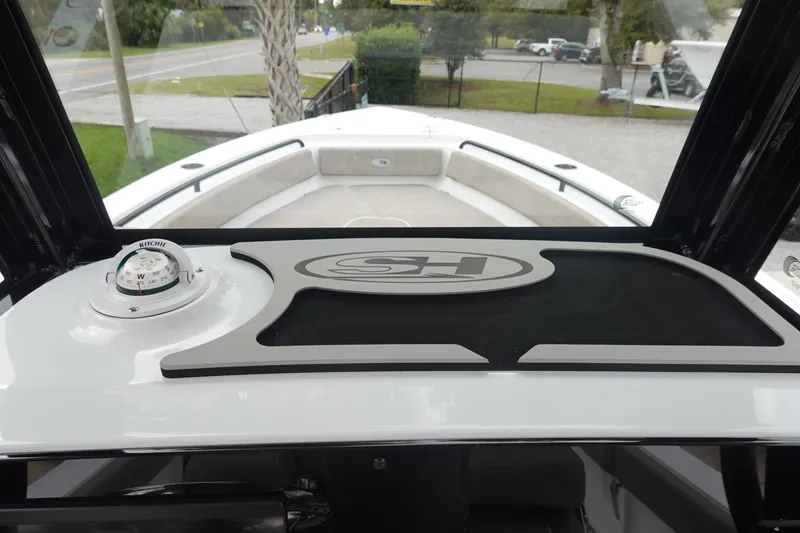 Slide: The Image of 2026 Sea Hunt Ultra 245 SE boat interior with compass and dashboard view. - 19