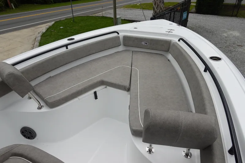 Slide: The Image of 2026 Sea Hunt Ultra 245 SE boat interior with gray cushioned seating and sleek design. - 22