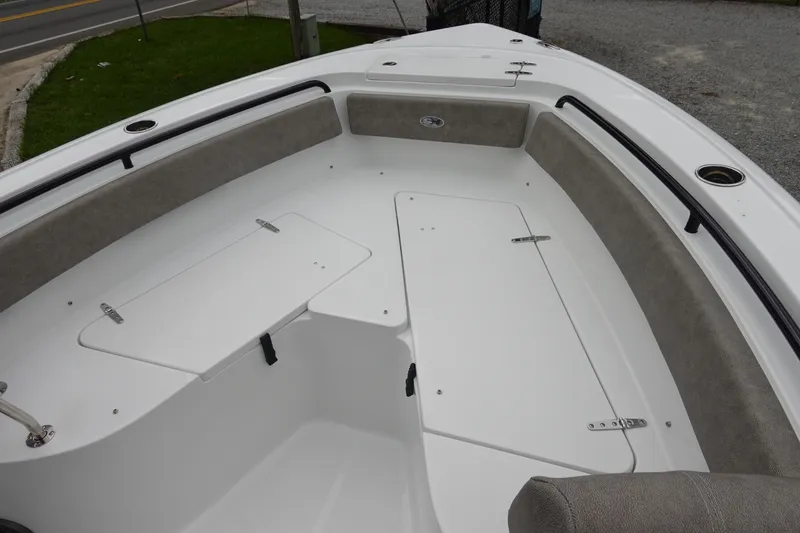 Slide: The Image of 2026 Sea Hunt Ultra 245 SE boat interior with cushioned seating and storage compartments. - 24