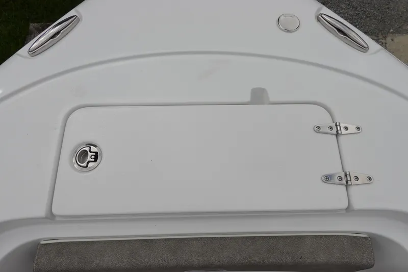 Slide: The Image of 2026 Sea Hunt Ultra 245 SE boat deck with storage compartment and stainless steel fittings. - 26