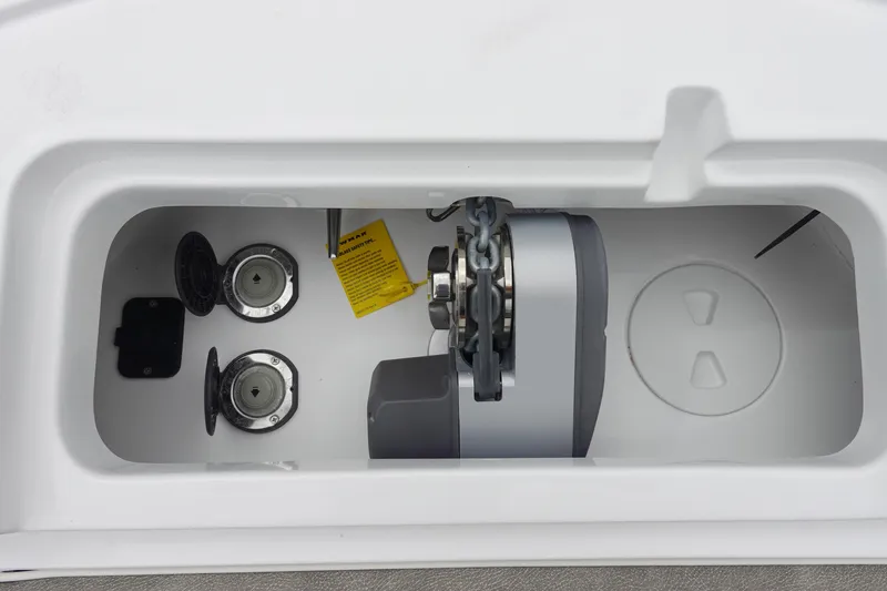 Slide: The Image of Anchor compartment of 2026 Sea Hunt Ultra 245 SE boat, featuring chain and fittings. - 27