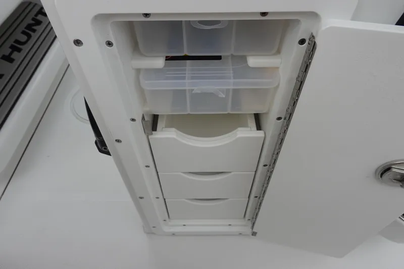 Slide: The Image of Storage compartment with drawers on a 2026 Sea Hunt Ultra 245 SE boat. - 33