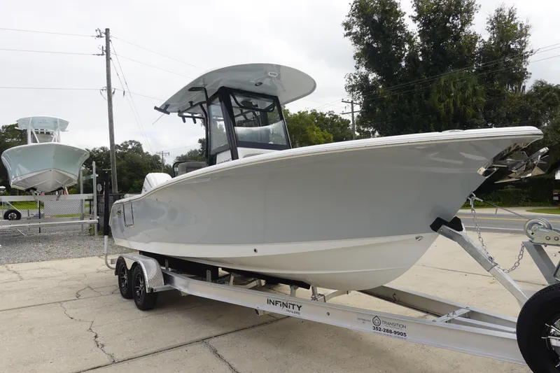 Slide: The Image of 2026 Sea Hunt Ultra 245 SE boat on trailer, parked outdoors. - 4