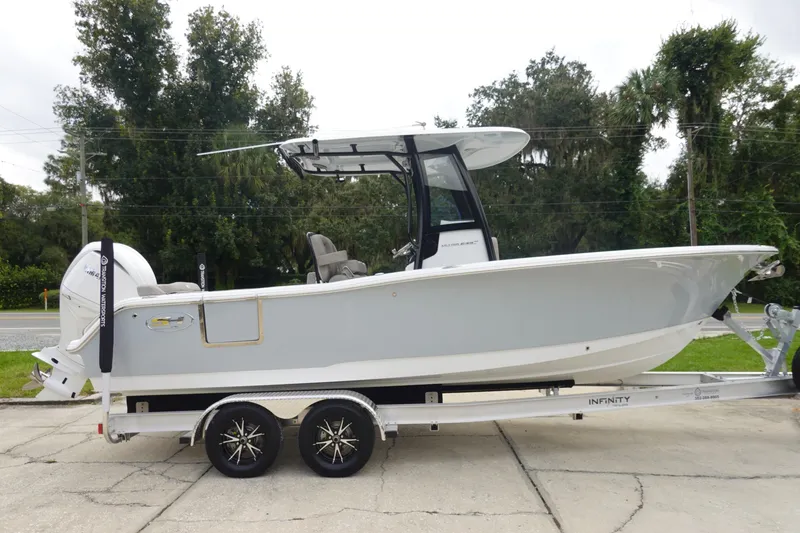 Slide: The Image of 2026 Sea Hunt Ultra 245 SE boat on trailer, side view, outdoors. - 5