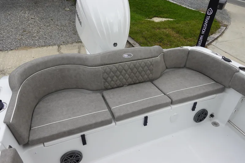 Slide: The Image of 2026 Sea Hunt Ultra 245 SE boat with gray cushioned seating and sleek design. - 8