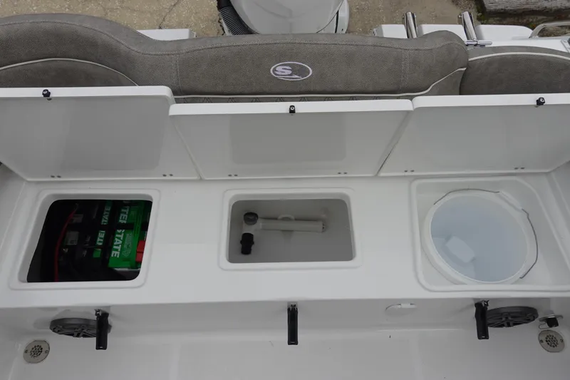 Slide: The Image of 2026 Sea Hunt Ultra 245 SE boat storage compartments and seating area. - 9