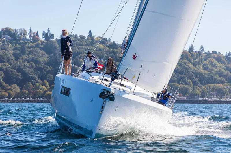 Slide: The Image of 2026 Jeanneau Sun Odyssey 490 sailing on a sunny day with crew onboard. - 3