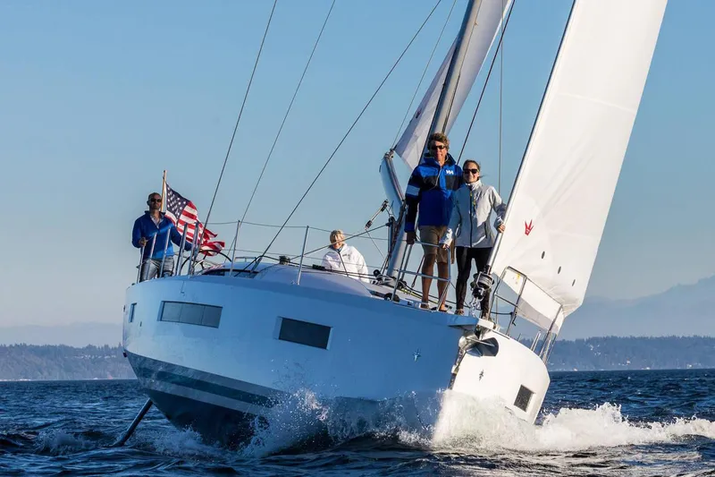 Slide: The Image of 2026 Jeanneau Sun Odyssey 490 sailing with crew on open water. - 4