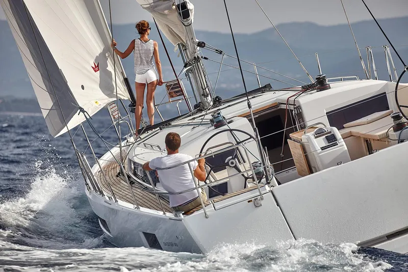 Slide: The Image of 2026 Jeanneau Sun Odyssey 490 sailing on open water with two people onboard. - 5