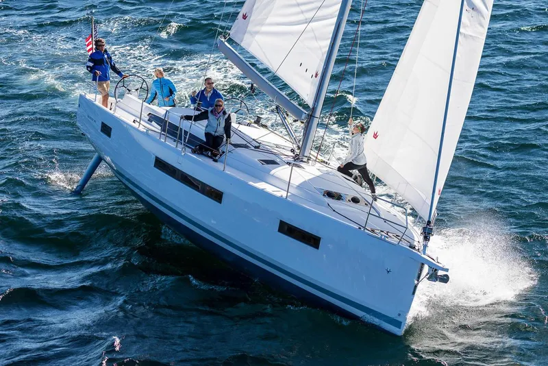 Slide: The Image of 2026 Jeanneau Sun Odyssey 490 sailing on open water with crew onboard. - 6