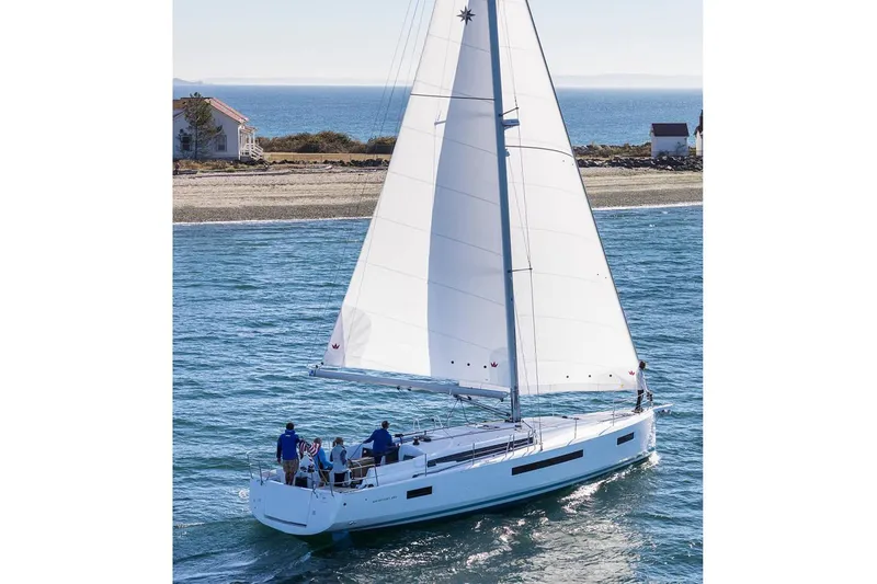 Slide: The Image of 2026 Jeanneau Sun Odyssey 490 sailing near a coastal shoreline. - 7