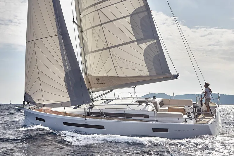 Slide: The Image of 2026 Jeanneau Sun Odyssey 490 sailing on open water, showcasing elegant design and performance. - 8