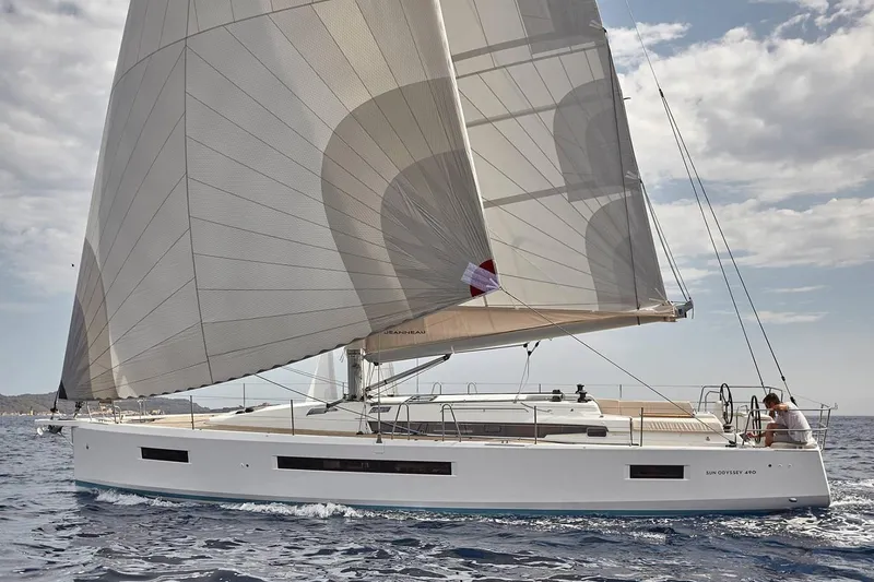 Slide: The Image of 2026 Jeanneau Sun Odyssey 490 sailing on open water under clear skies. - 9