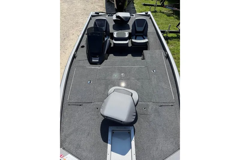 Slide: The Image of 2026 Lowe Stinger 175C boat interior with seating and storage compartments. - 2