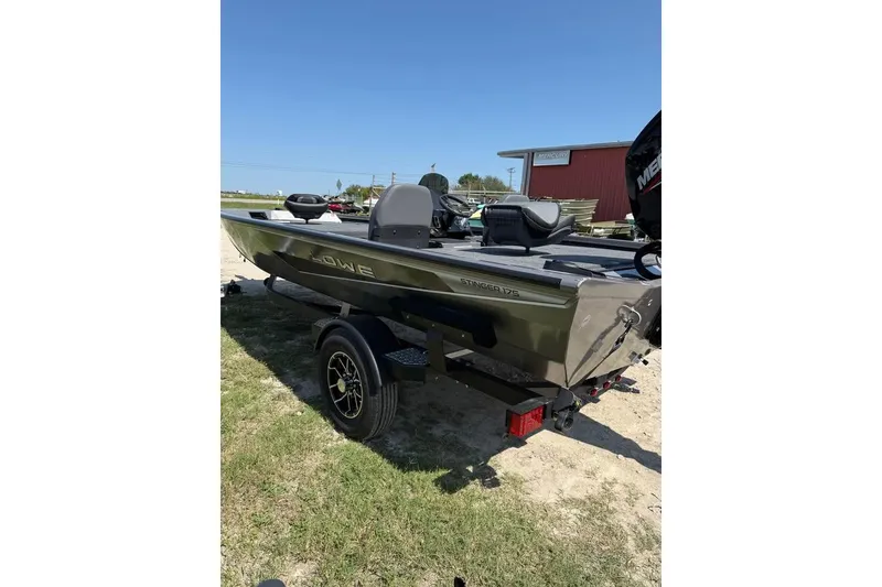 Slide: The Image of 2026 Lowe Stinger 175C fishing boat on trailer, parked outdoors. - 3