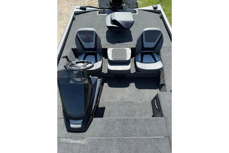 Slide: The Image of 2026 Lowe Stinger 175C boat interior with seating and steering console. - 6