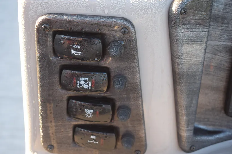 Slide: The Image of Control panel of 2023 Qwest 818 XRE E Class XRE Fish LT with horn and light switches. - 12