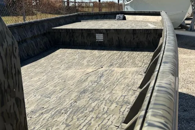 Slide: The Image of 2025 SeaArk 1860 MVJT boat interior with camouflage design, showcasing spacious deck and durable construction. - 4