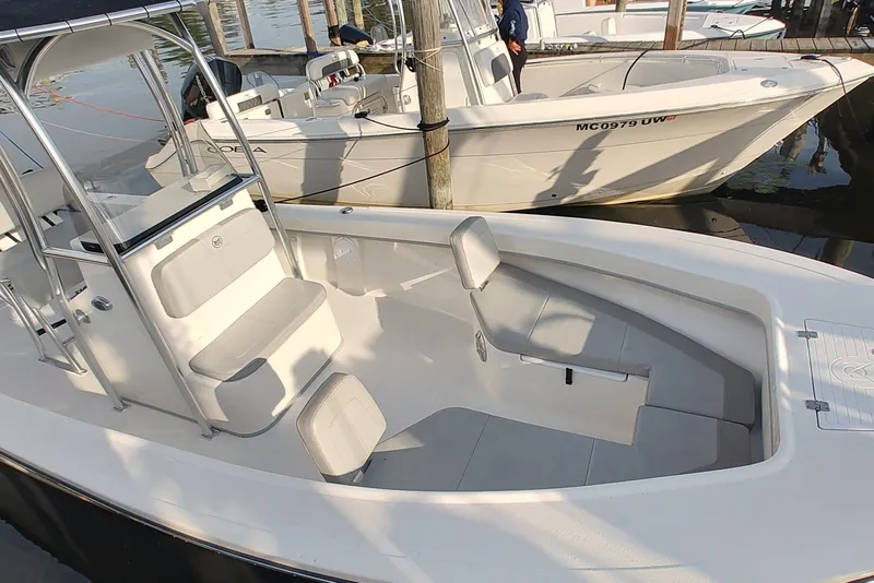 Slide: The Image of 2024 Mayfield 238CC boat docked, showcasing spacious seating and sleek design. - 2