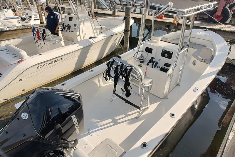 Slide: The Image of 2024 Mayfield 238CC boat docked, featuring a sleek design and modern controls. - 3