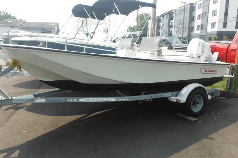 Slide: The Image of 1988 Boston Whaler 17 Super Sport boat on trailer, parked outdoors. - 1
