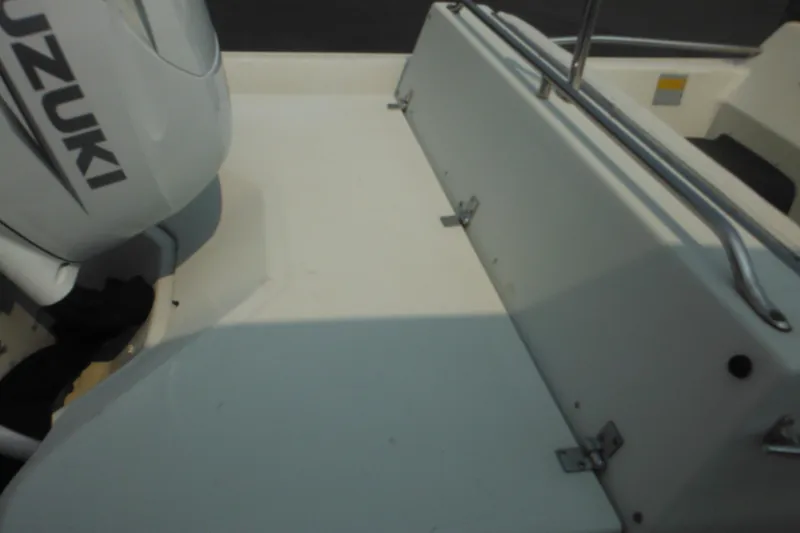 Slide: The Image of 1988 Boston Whaler 17 Super Sport boat interior with Suzuki engine. - 14