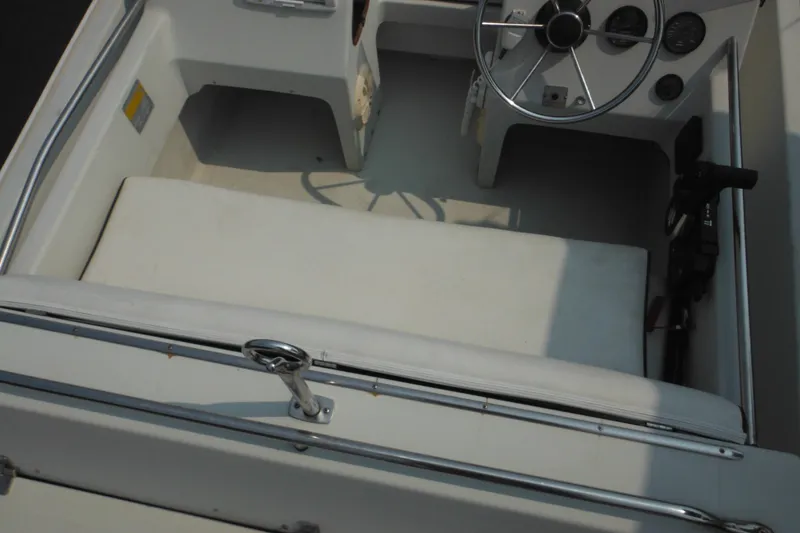 Slide: The Image of 1988 Boston Whaler 17 Super Sport interior with steering wheel and seating area. - 16