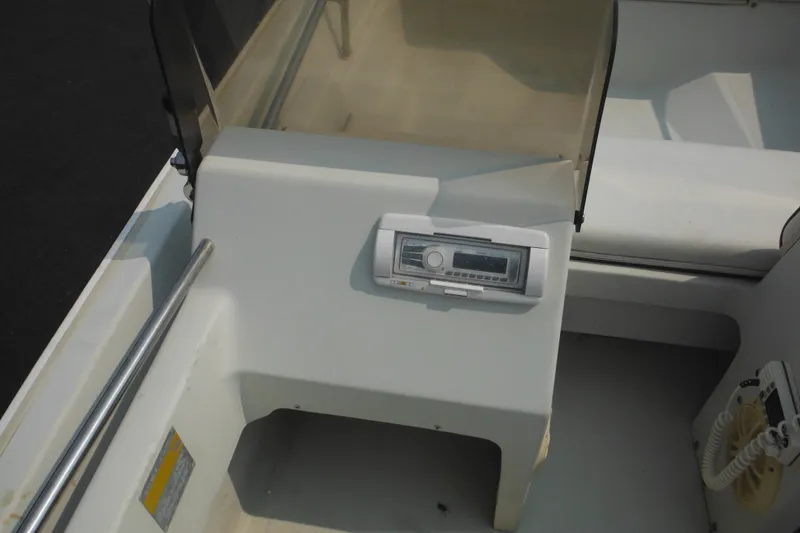 Slide: The Image of 1988 Boston Whaler 17 Super Sport dashboard with radio and steering console. - 18
