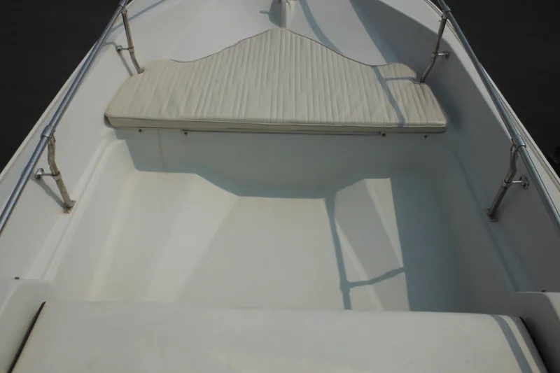 Slide: The Image of 1988 Boston Whaler 17 Super Sport interior with cushioned seating and stainless steel railings. - 19