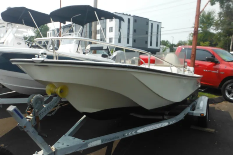 Slide: The Image of 1988 Boston Whaler 17 Super Sport boat on trailer, parked outdoors. - 2