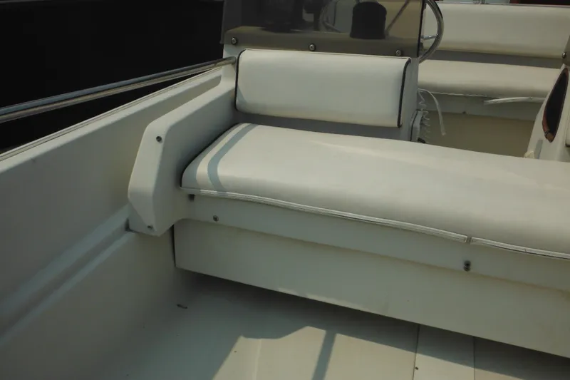 Slide: The Image of 1988 Boston Whaler 17 Super Sport interior seating with white cushions. - 22