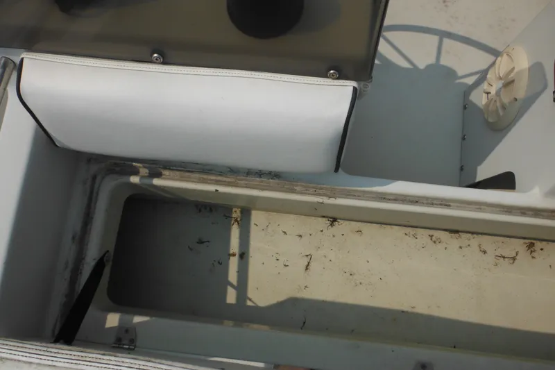 Slide: The Image of 1988 Boston Whaler 17 Super Sport interior showing storage compartment and seating area. - 23