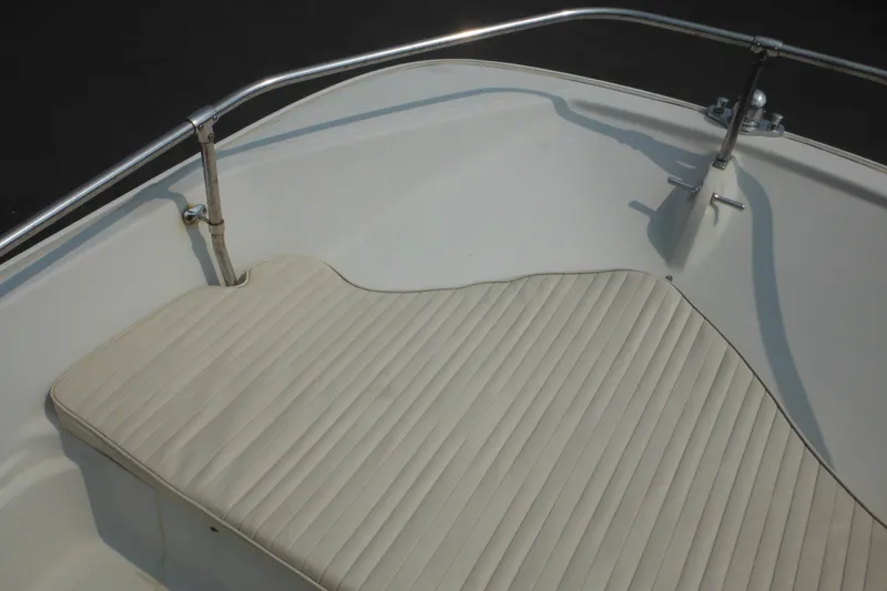Slide: The Image of 1988 Boston Whaler 17 Super Sport boat interior with cushioned seating and stainless steel railing. - 25
