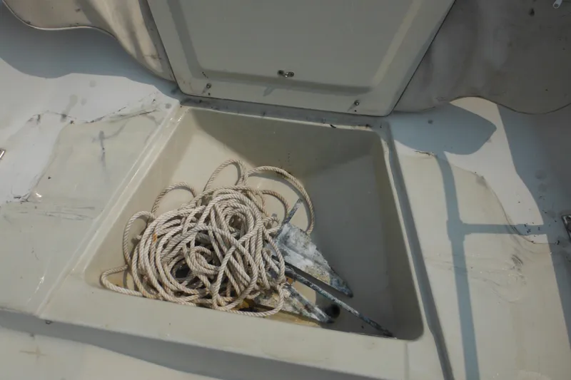 Slide: The Image of Anchor and rope in storage compartment of 1988 Boston Whaler 17 Super Sport boat. - 26