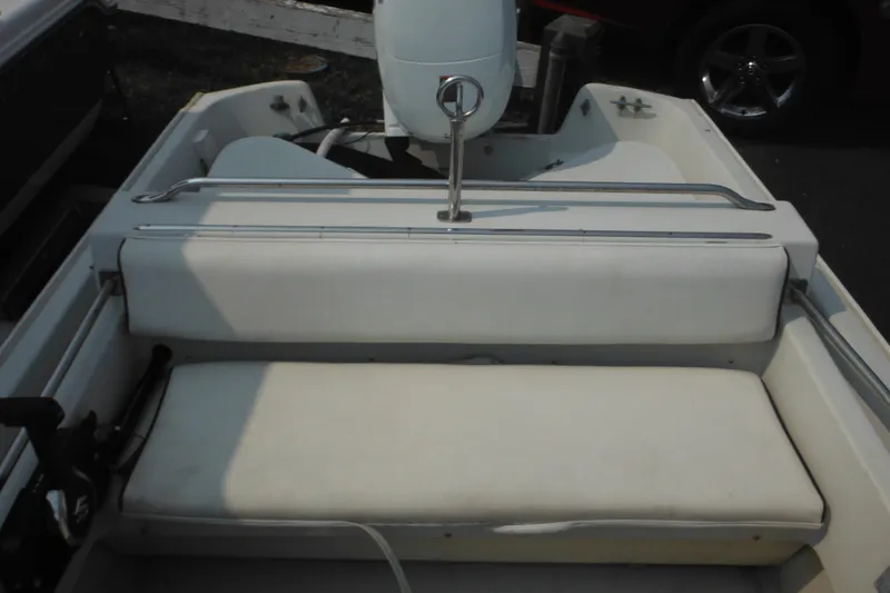Slide: The Image of 1988 Boston Whaler 17 Super Sport interior with white seating and metal railings. - 27