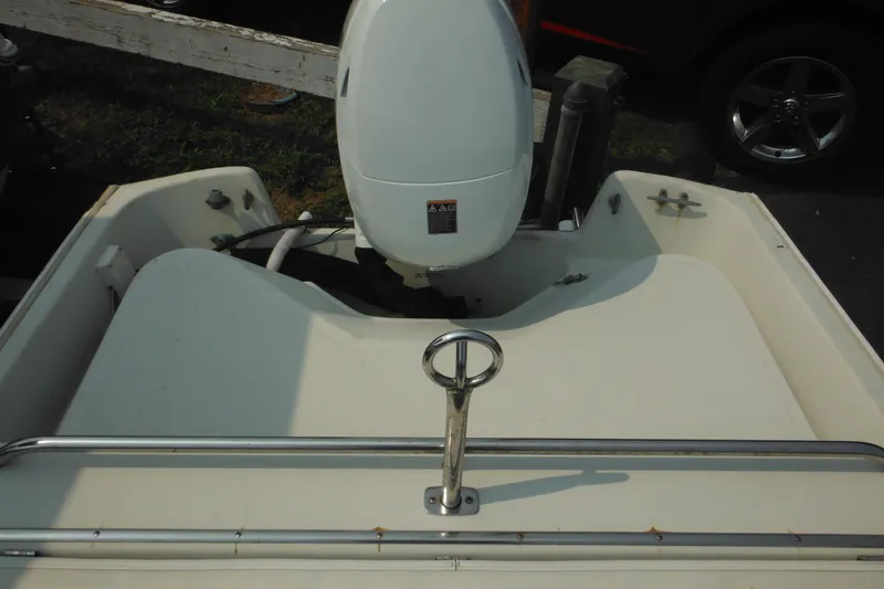 Slide: The Image of 1988 Boston Whaler 17 Super Sport boat with outboard motor, rear view. - 28