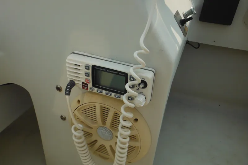 Slide: The Image of VHF radio and speaker on 1988 Boston Whaler 17 Super Sport boat console. - 30