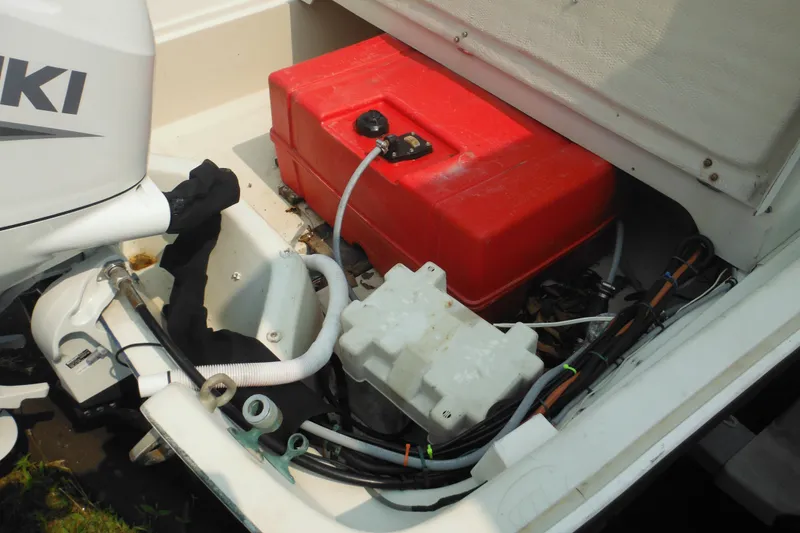Slide: The Image of 1988 Boston Whaler 17 Super Sport boat engine compartment with red fuel tank and wiring. - 33