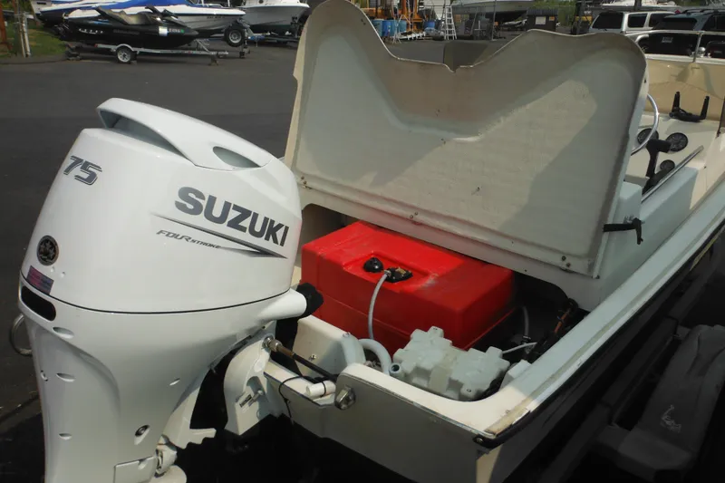 Slide: The Image of 1988 Boston Whaler 17 Super Sport with Suzuki 75 outboard motor, open storage compartment. - 34