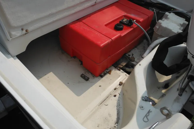 Slide: The Image of 1988 Boston Whaler 17 Super Sport interior with red fuel tank and engine components. - 37